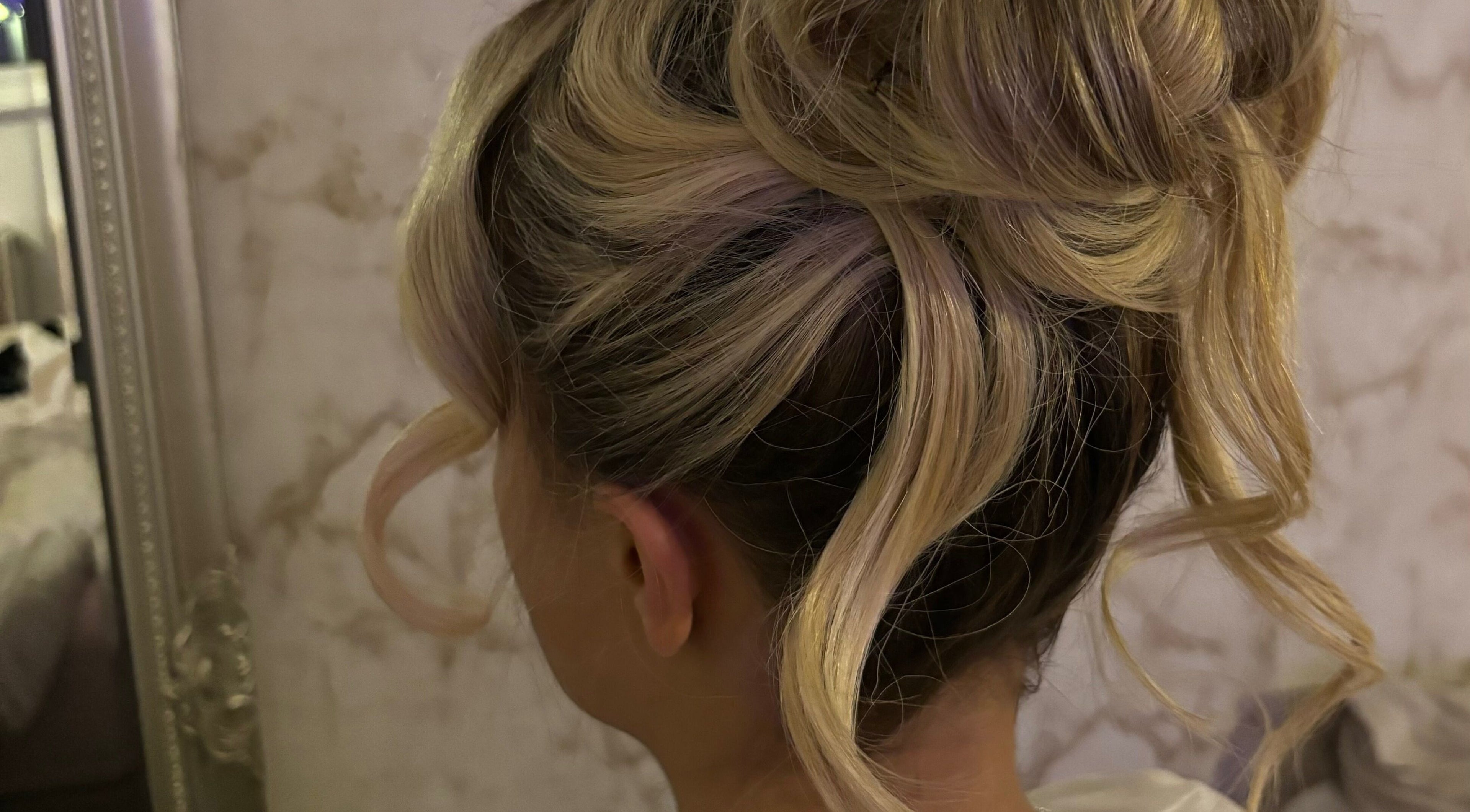Elegant updo hairstyle at LM Blowdries, Bettws, Wales, GB, showcasing beautiful blonde curls.