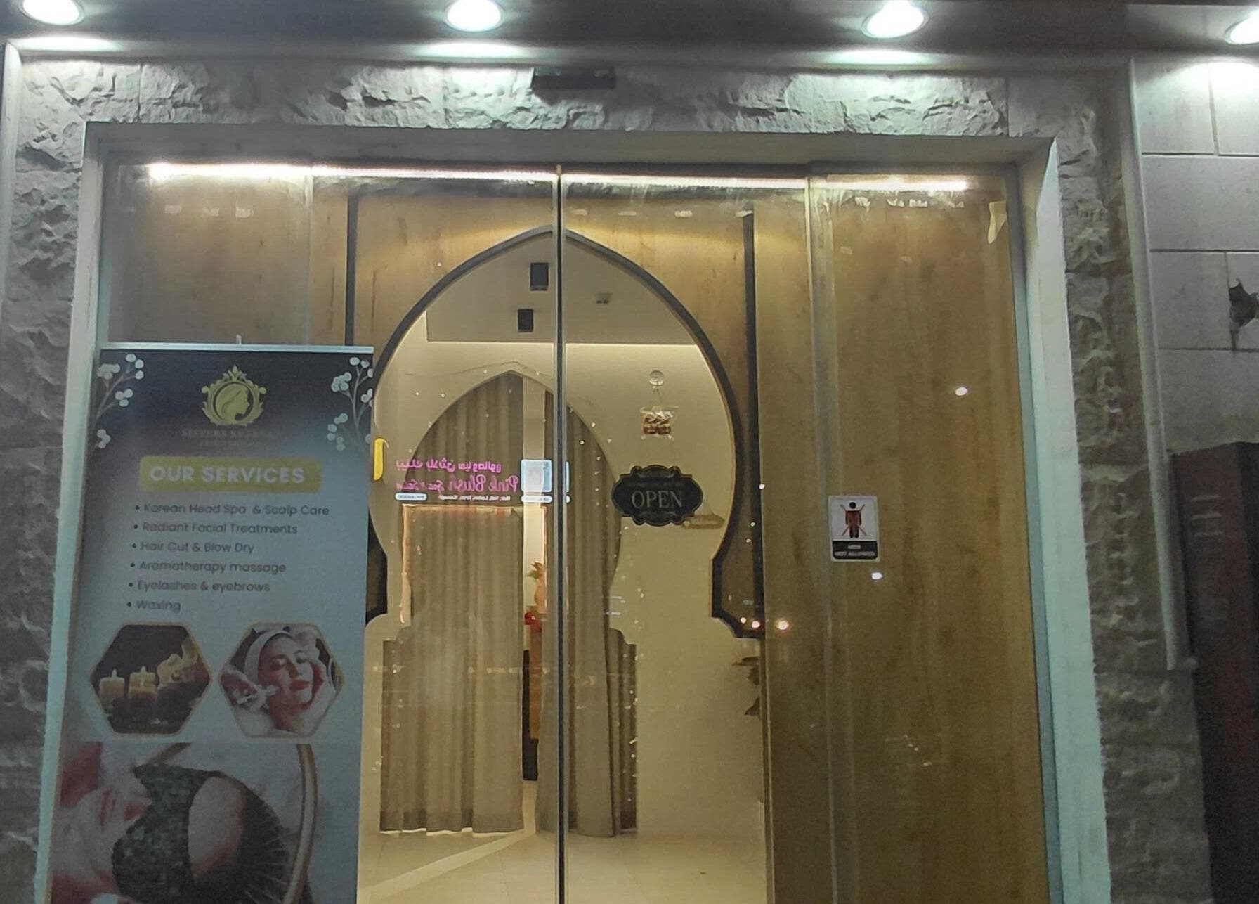 Front view of Sisters Retreat Salon and Spa in Doha, showcasing its welcoming entrance and services banner.