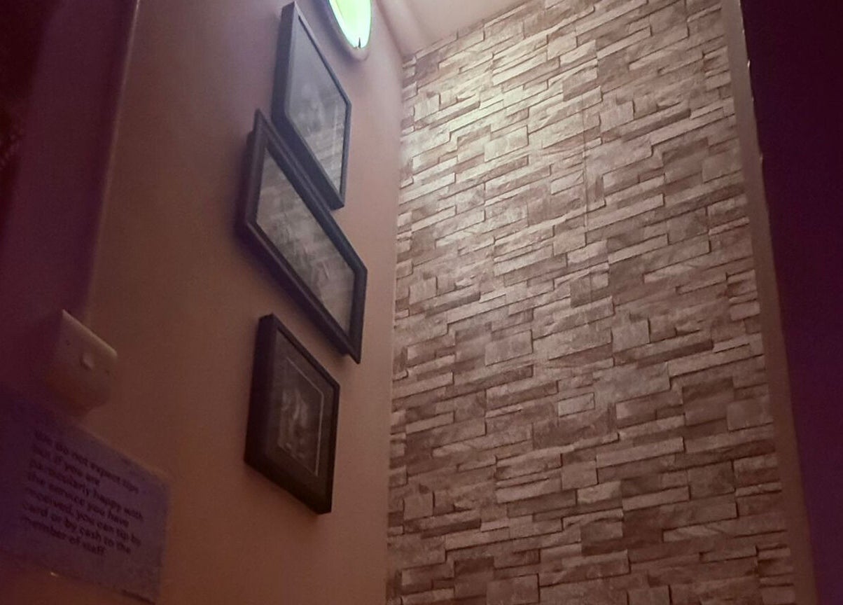 Modern interior wall with framed art at Nisa Thai Spa near Buckingham Palace, London, England, GB.