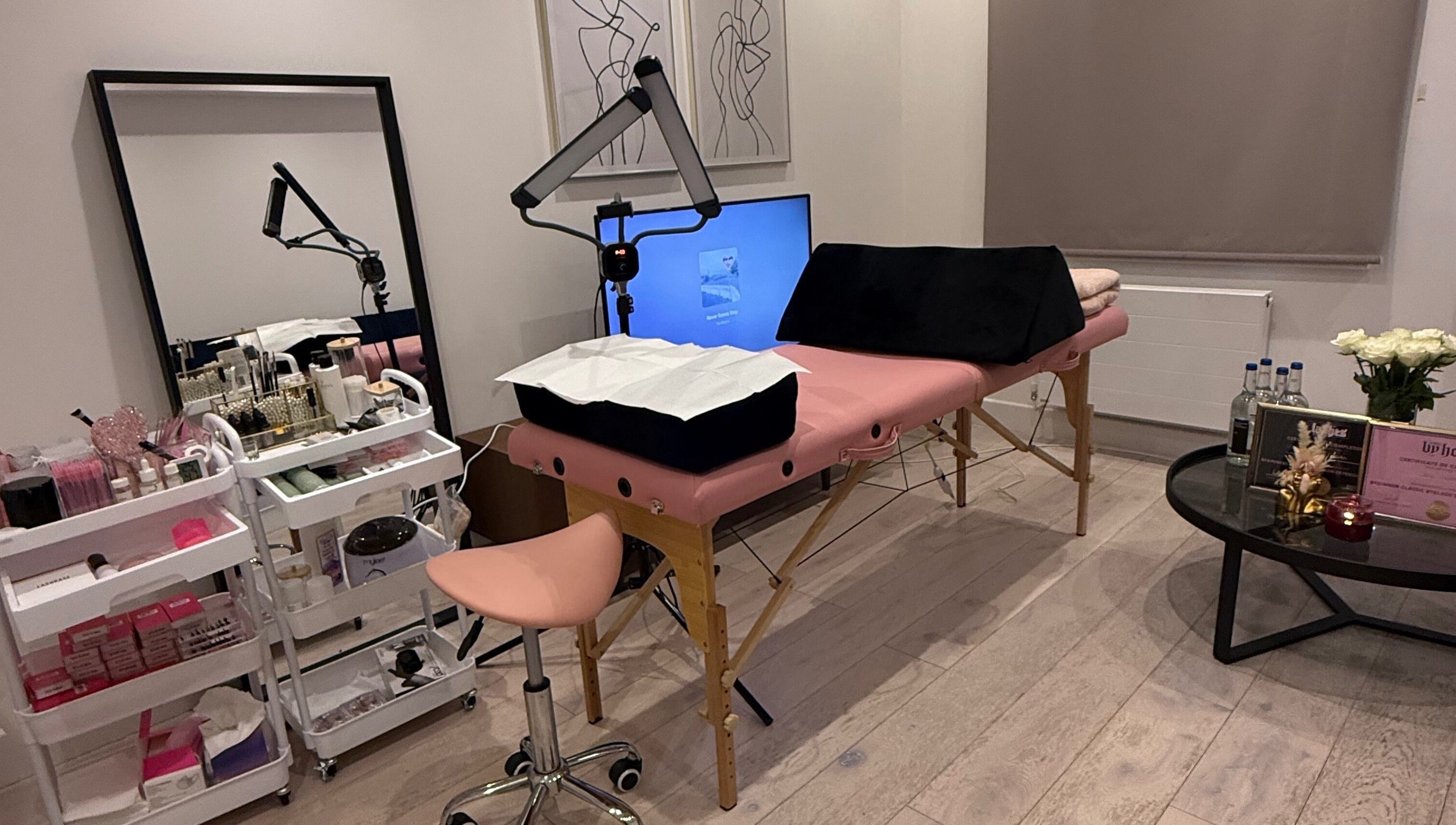 Tranquil treatment room at Sara’s Beauty Bar, Isleworth, England, GB, featuring cozy setup and elegant decor.