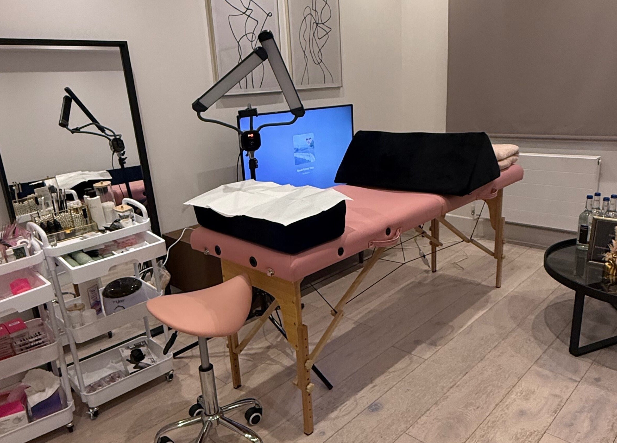 Tranquil treatment room at Sara’s Beauty Bar, Isleworth, England, GB, featuring cozy setup and elegant decor.
