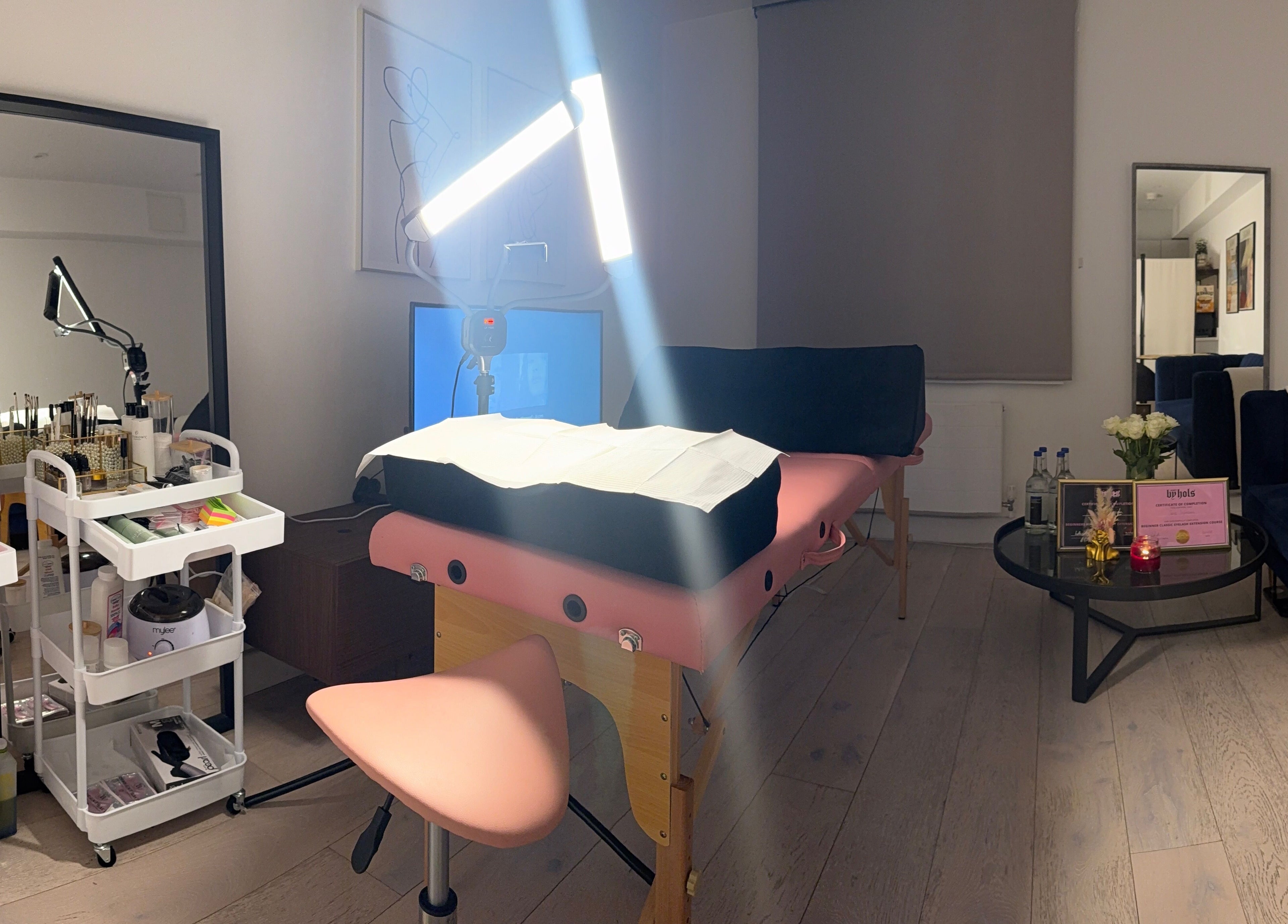 Cozy treatment space at Sara’s Beauty Bar, Isleworth, England, GB, featuring massage bed and beauty products.