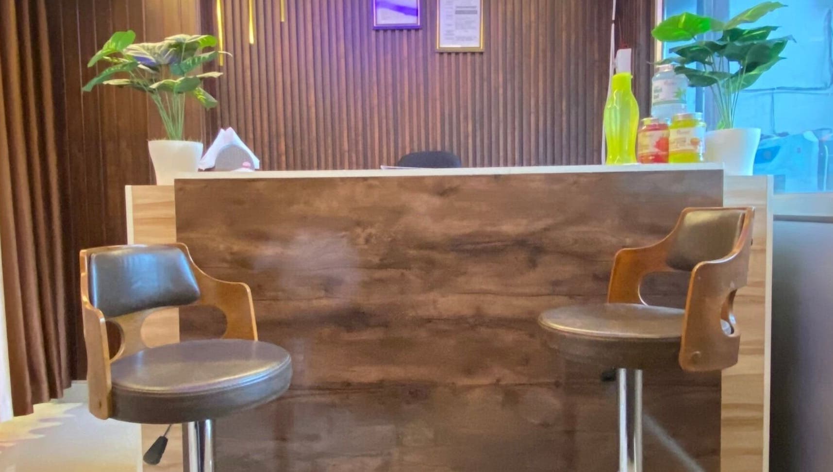 Reception area at Glamour Welness Spa, Bengaluru, Karnataka, IN with chairs and decor.