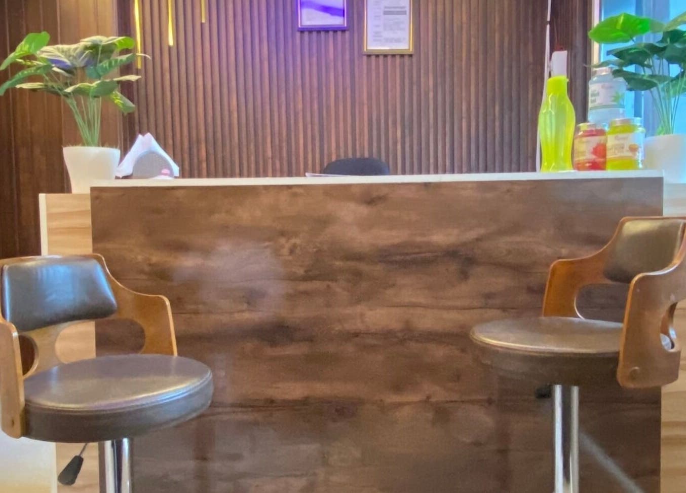 Reception area at Glamour Welness Spa, Bengaluru, Karnataka, IN with chairs and decor.