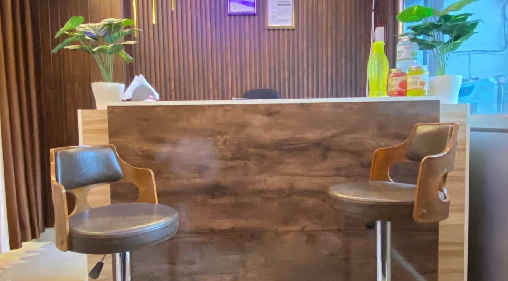 Reception area at Glamour Welness Spa, Bengaluru, Karnataka, IN with chairs and decor.