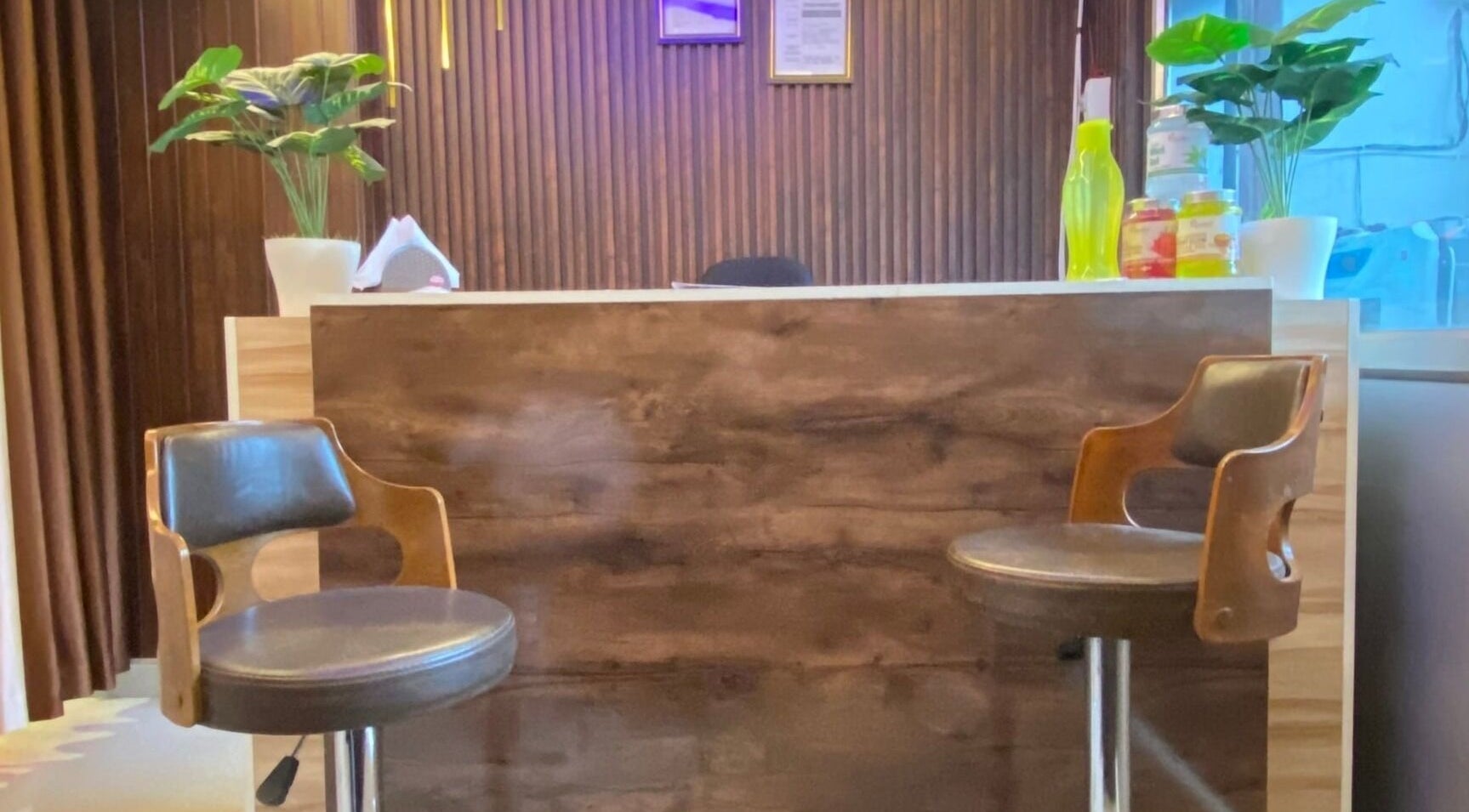 Reception area at Glamour Welness Spa, Bengaluru, Karnataka, IN with chairs and decor.