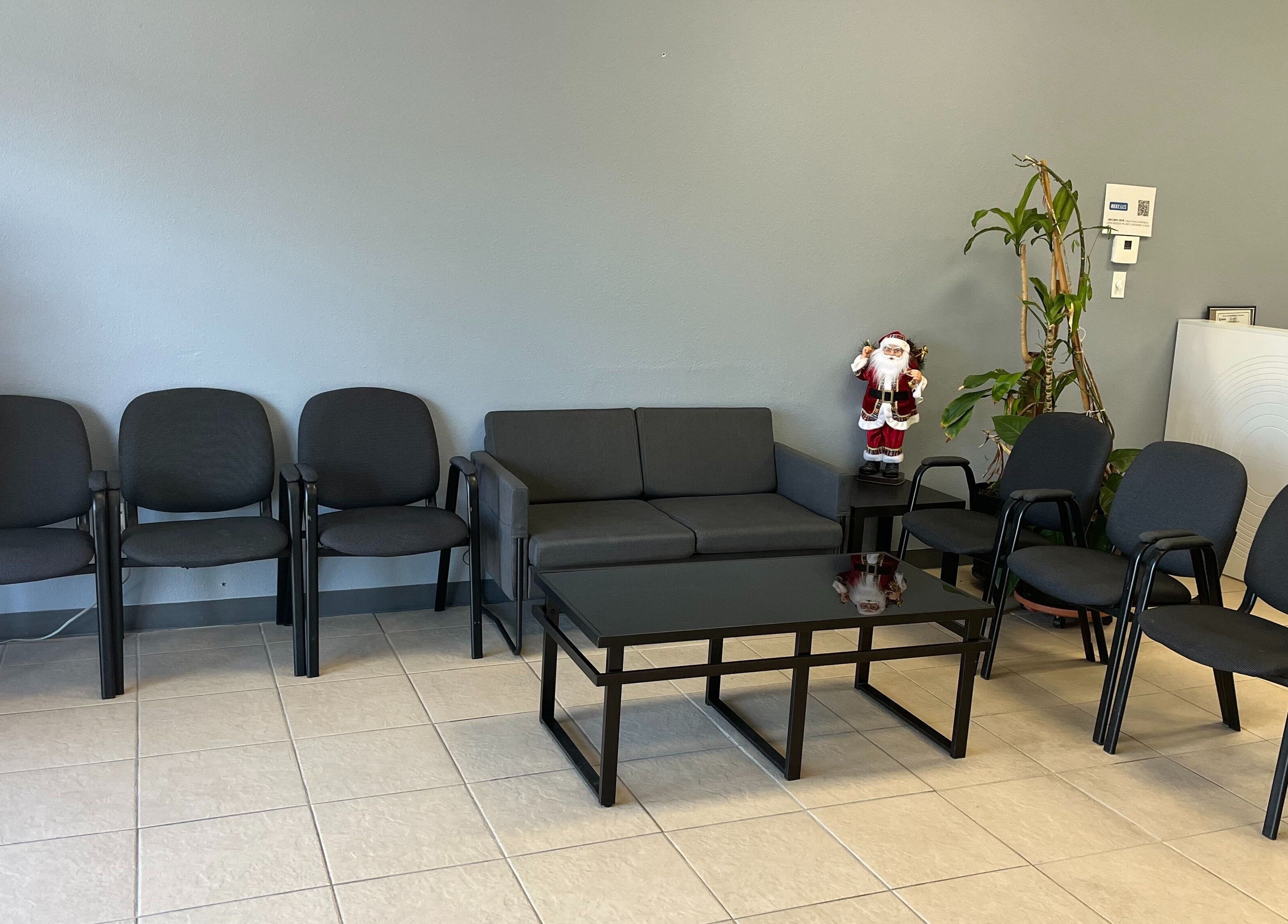 Modern waiting area at BEST CUTS, Wildomar, California, US, with seating and decor.