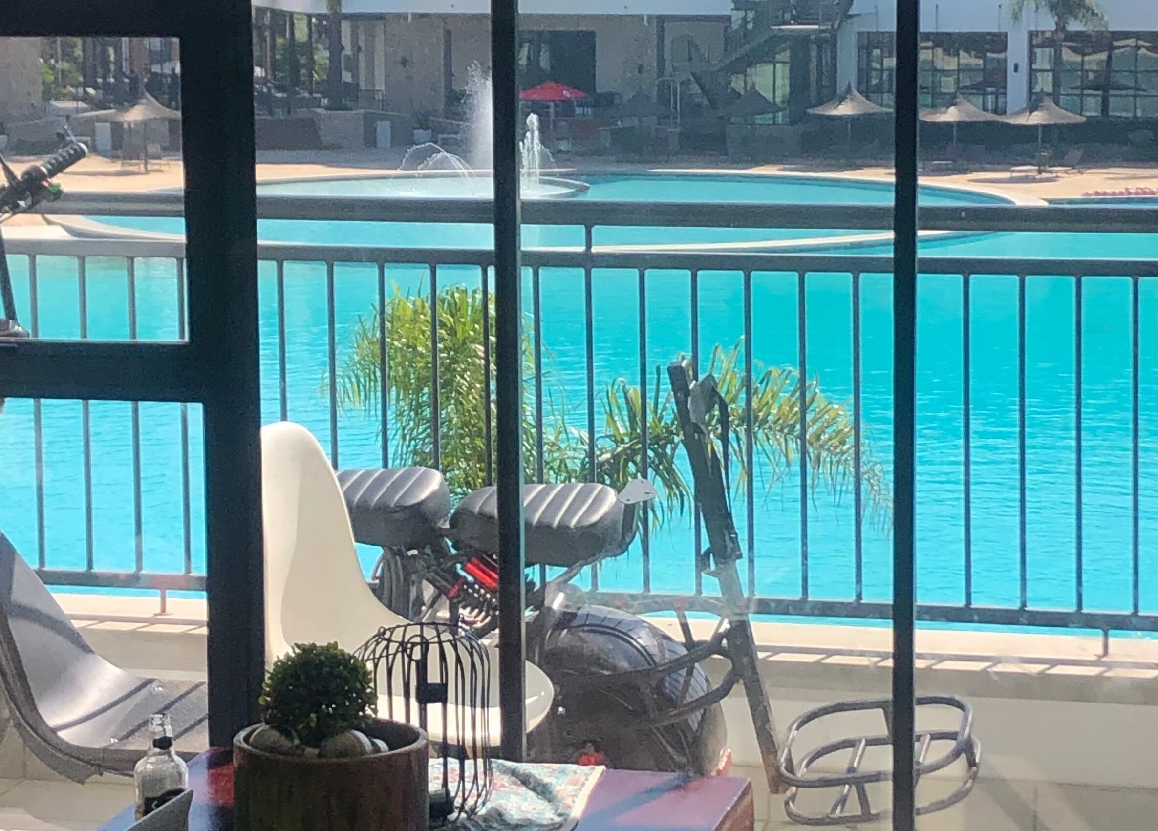 View from Glizzy Cuts, Pretoria, Gauteng, ZA, showing poolside scooter and inviting pool ambiance.