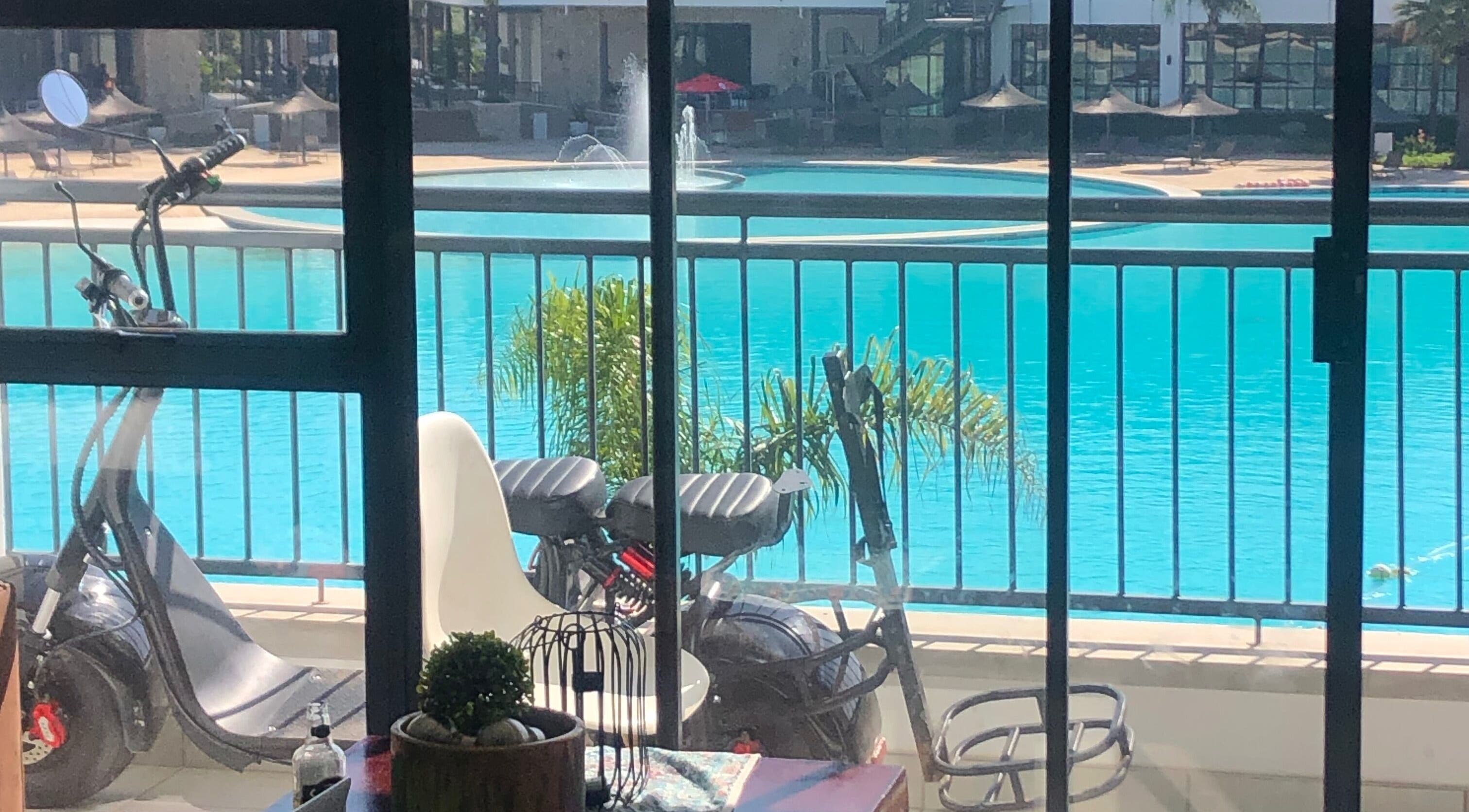 View from Glizzy Cuts, Pretoria, Gauteng, ZA, showing poolside scooter and inviting pool ambiance.