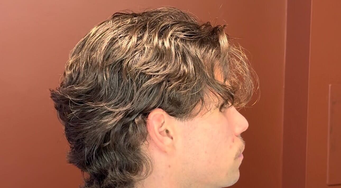 Side profile of a man with stylish wavy hair at Velor Studio in Waterloo, Ontario, CA.