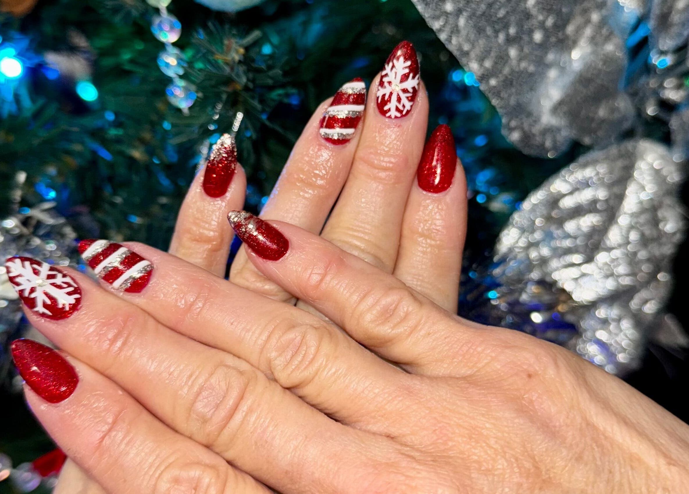 Festive red and white nail design at The Cass Effect, Deland, Florida, US.
