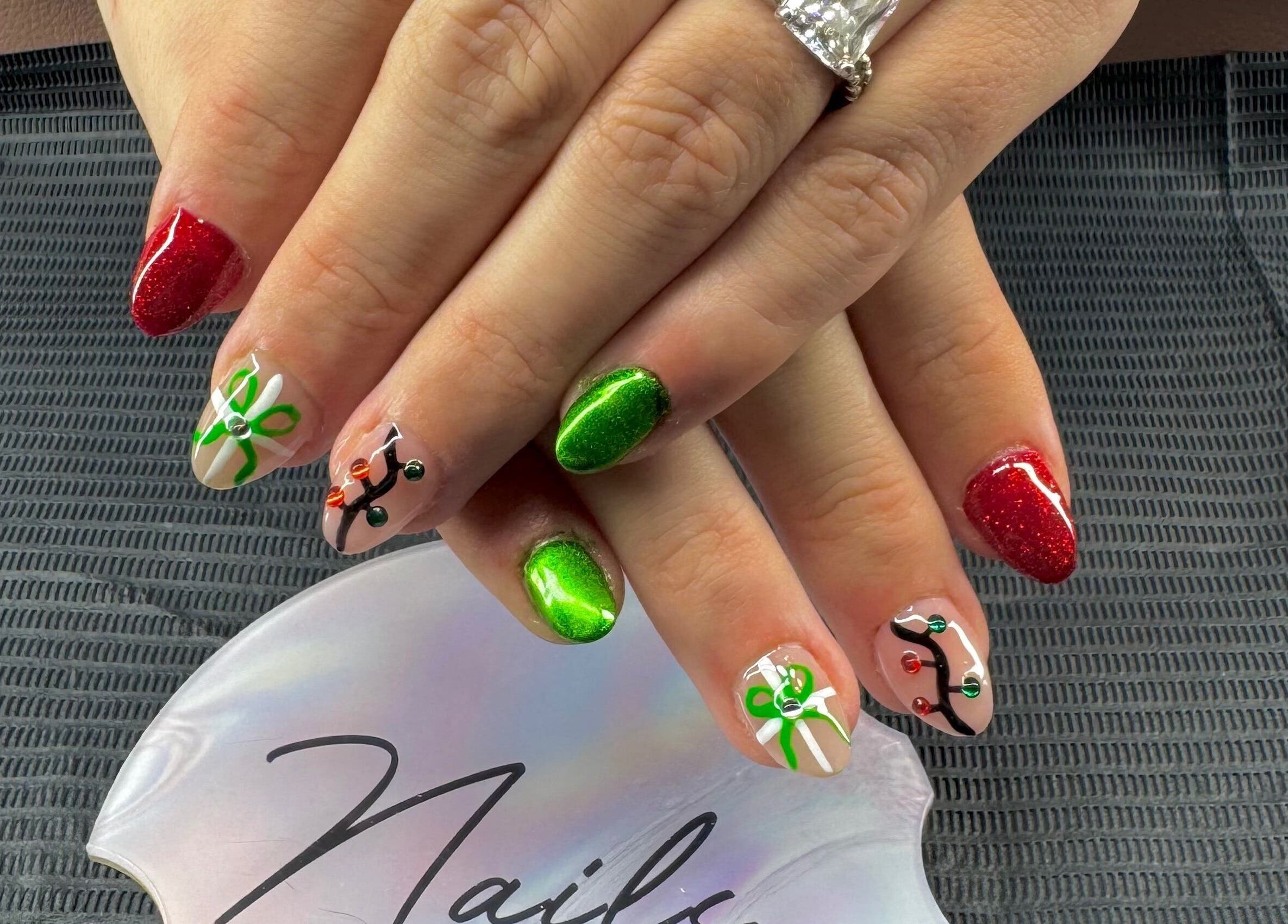 Festive nail art with red and green designs at The Cass Effect, Deland, Florida, US.