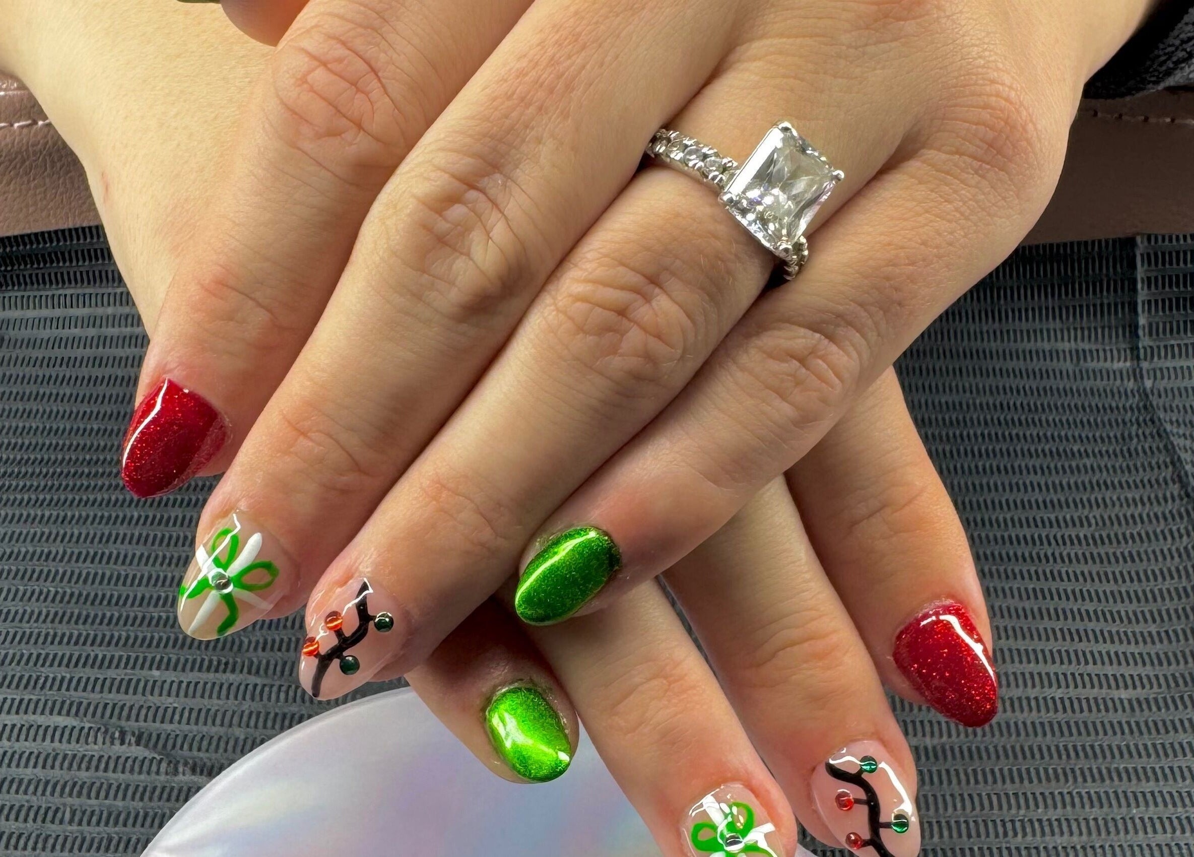 Festive nail art with red and green designs at The Cass Effect, Deland, Florida, US.