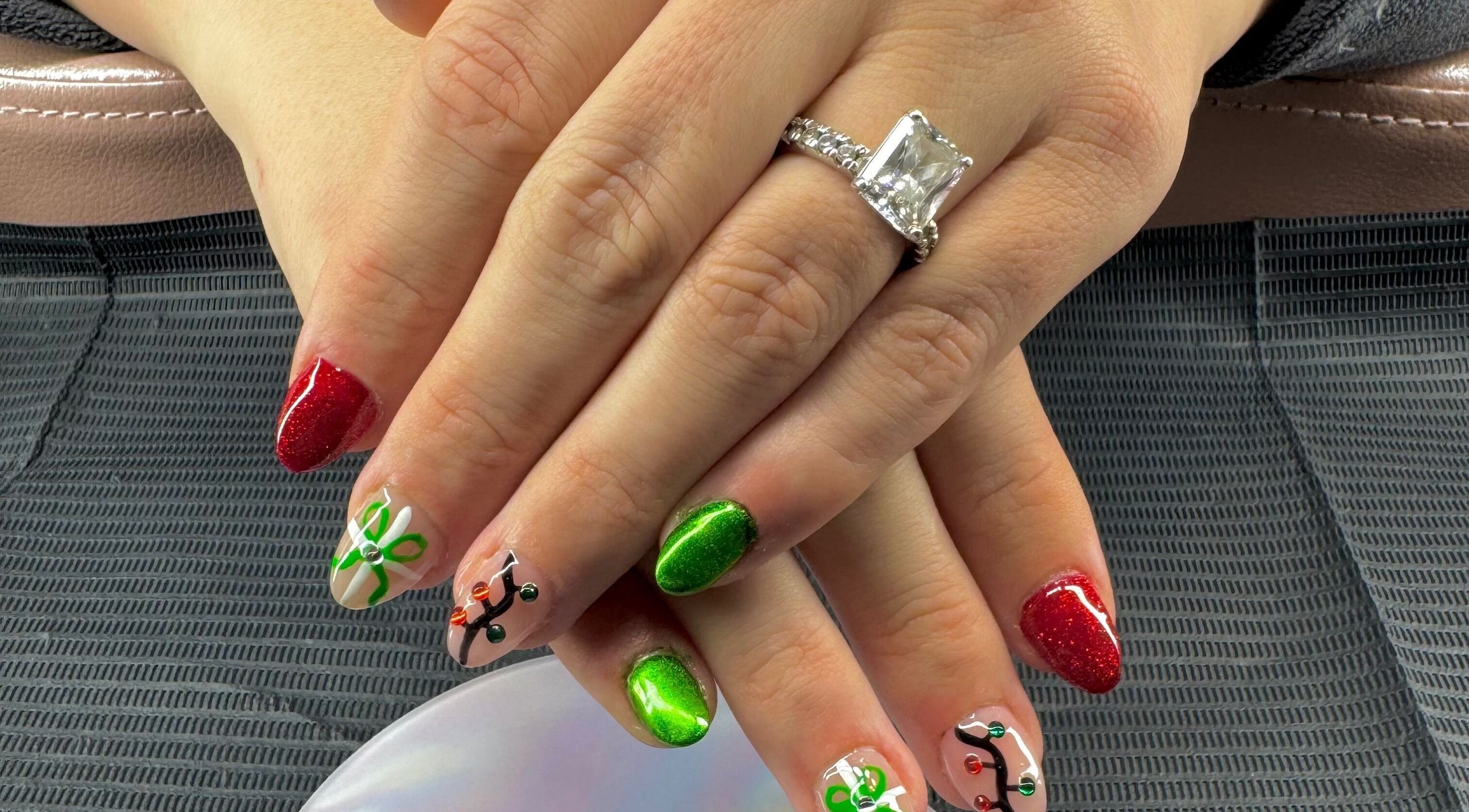 Festive nail art with red and green designs at The Cass Effect, Deland, Florida, US.