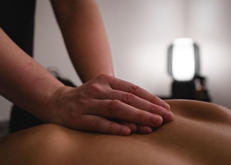 A soothing massage at Fitness Recovery and Massage in Leeds, England, GB. Close-up of a therapist's hands.