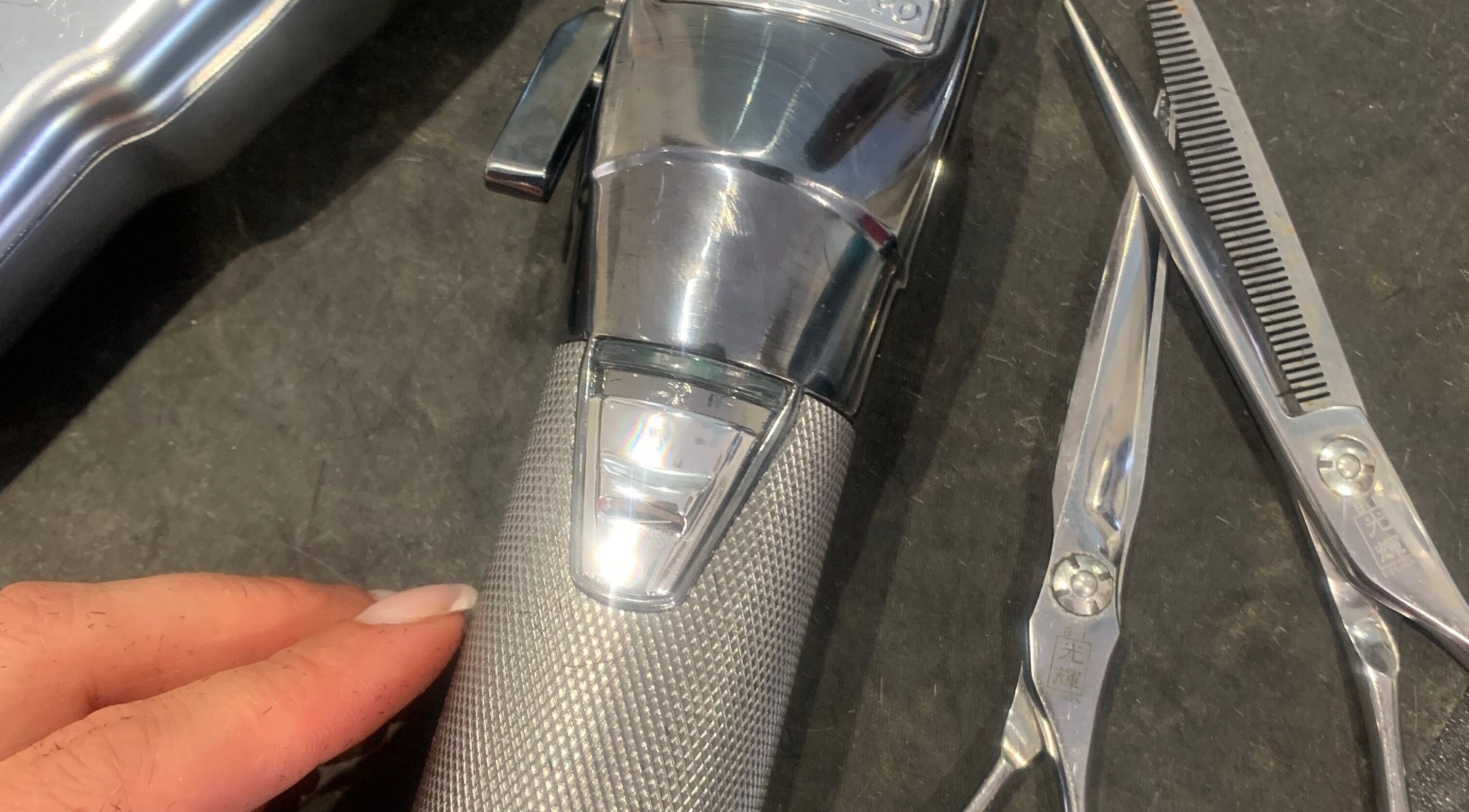 Professional hair clipper and scissors at Hair by Petra in Salisbury, England, GB, ready for styling.