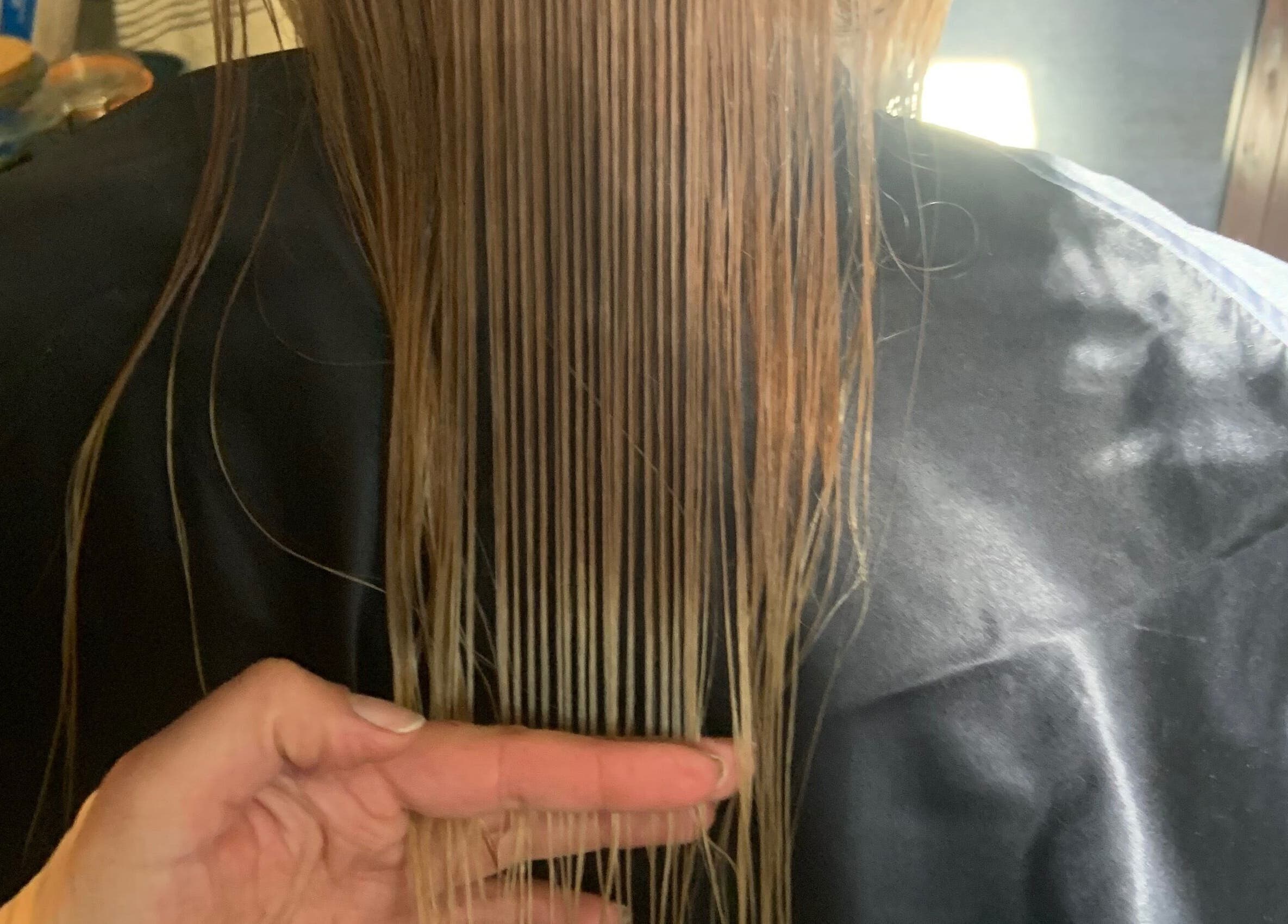 Close-up of hair being styled at Hair by Petra, Salisbury, England, GB showcasing sleek and smooth strands.