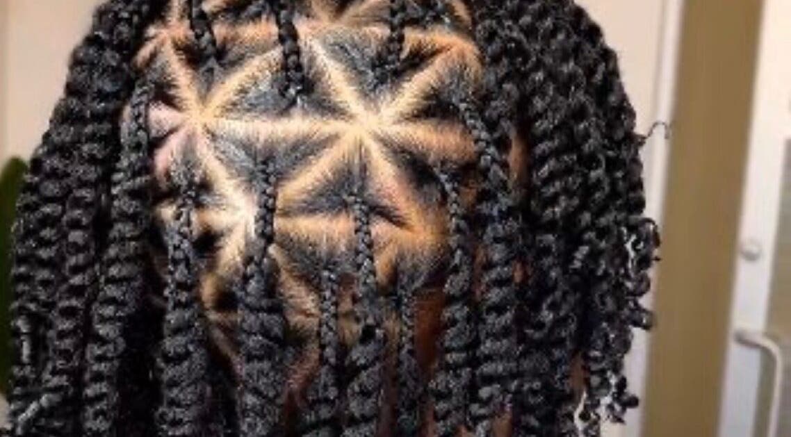 Intricate braided hairstyle showcased at Venus Hair and Beauty, Northolt, England, GB.