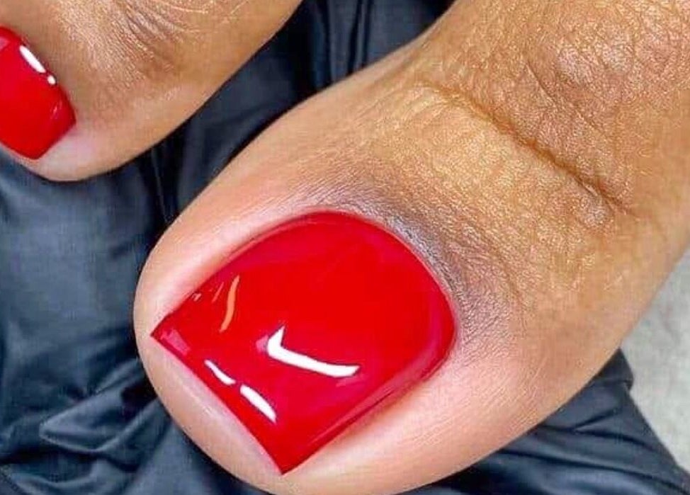 Close-up of bright red toenail polish at Pure Glow Mani And Pedi Mobile in Cape Town, Western Cape, ZA.