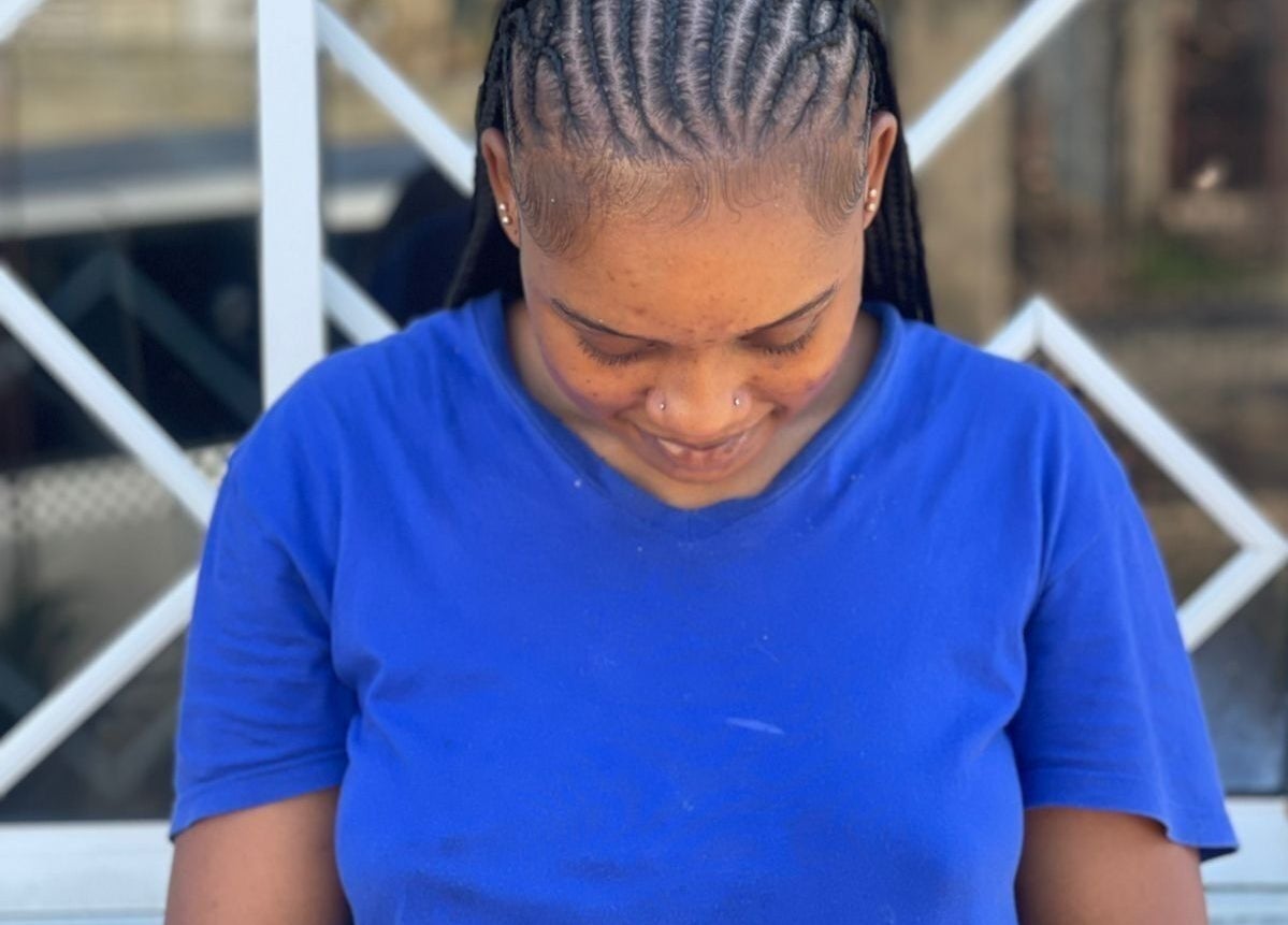 Woman with intricately styled braids at Braidsby_Sue in Montego Bay, St. James Parish, JM.