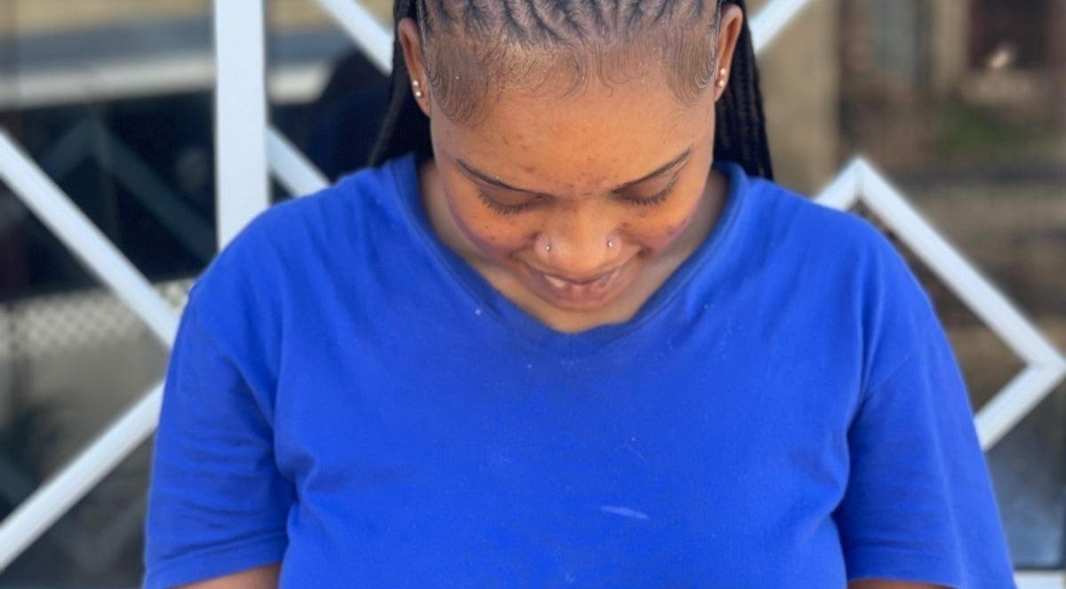Woman with intricately styled braids at Braidsby_Sue in Montego Bay, St. James Parish, JM.