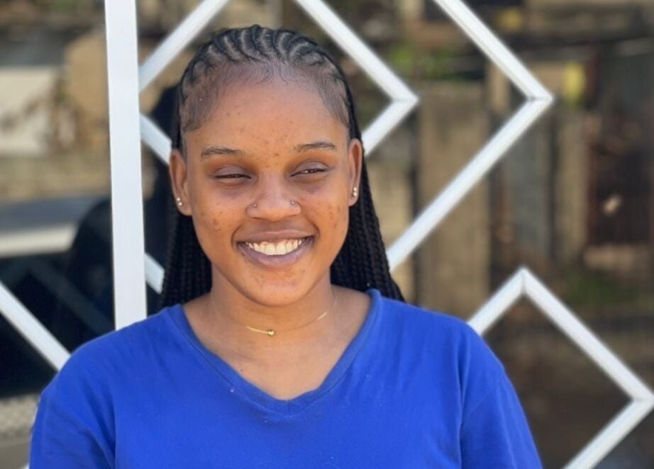 Smiling woman with braided hair at Braidsby Sue, Montego Bay, St. James Parish, JM.