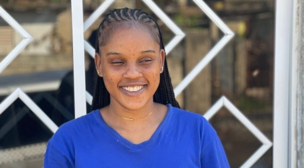 Smiling woman with braided hair at Braidsby Sue, Montego Bay, St. James Parish, JM.