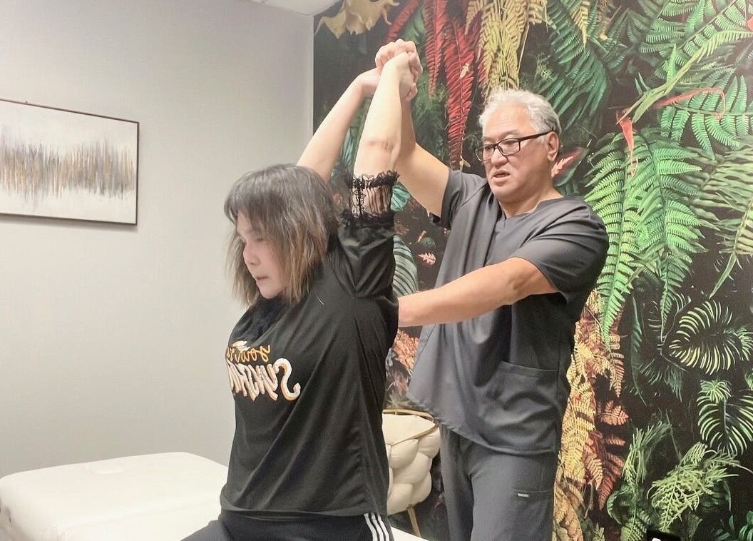 Professional wellness therapy session at THE REVIVE BAR located in Allen, Texas, US with a lush wall backdrop.