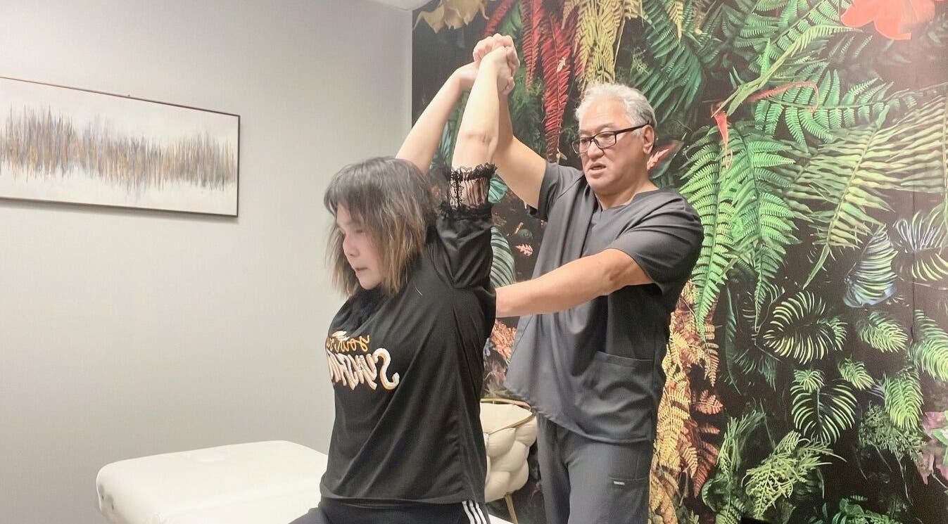 Professional wellness therapy session at THE REVIVE BAR located in Allen, Texas, US with a lush wall backdrop.