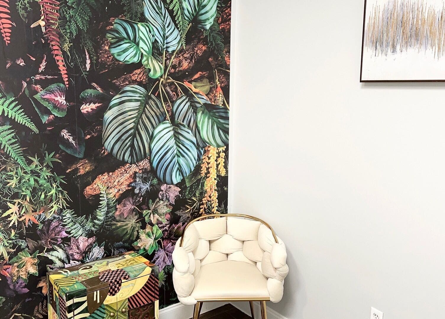 Artistic corner at THE REVIVE BAR, Allen, Texas, US, with vibrant plant mural and chic white chair.