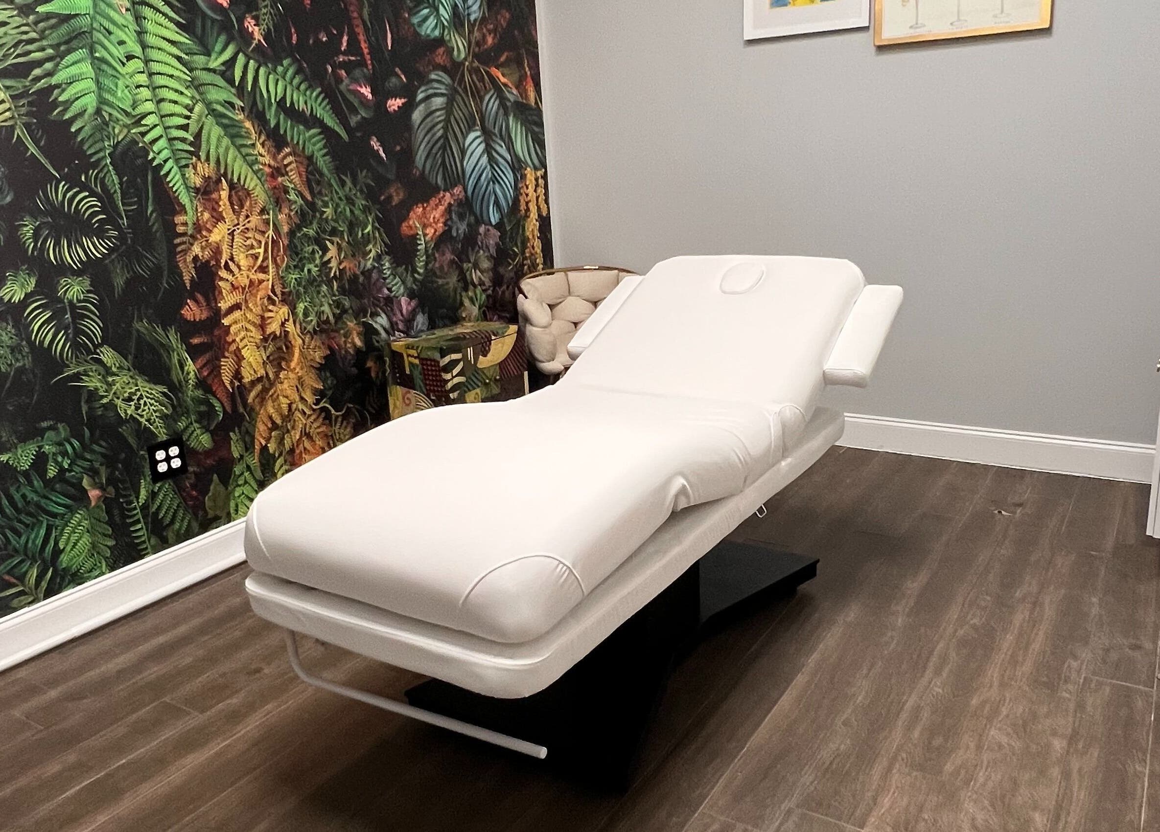 Luxurious treatment room at THE REVIVE BAR, Allen, Texas, US with a spa bed and tropical decor.