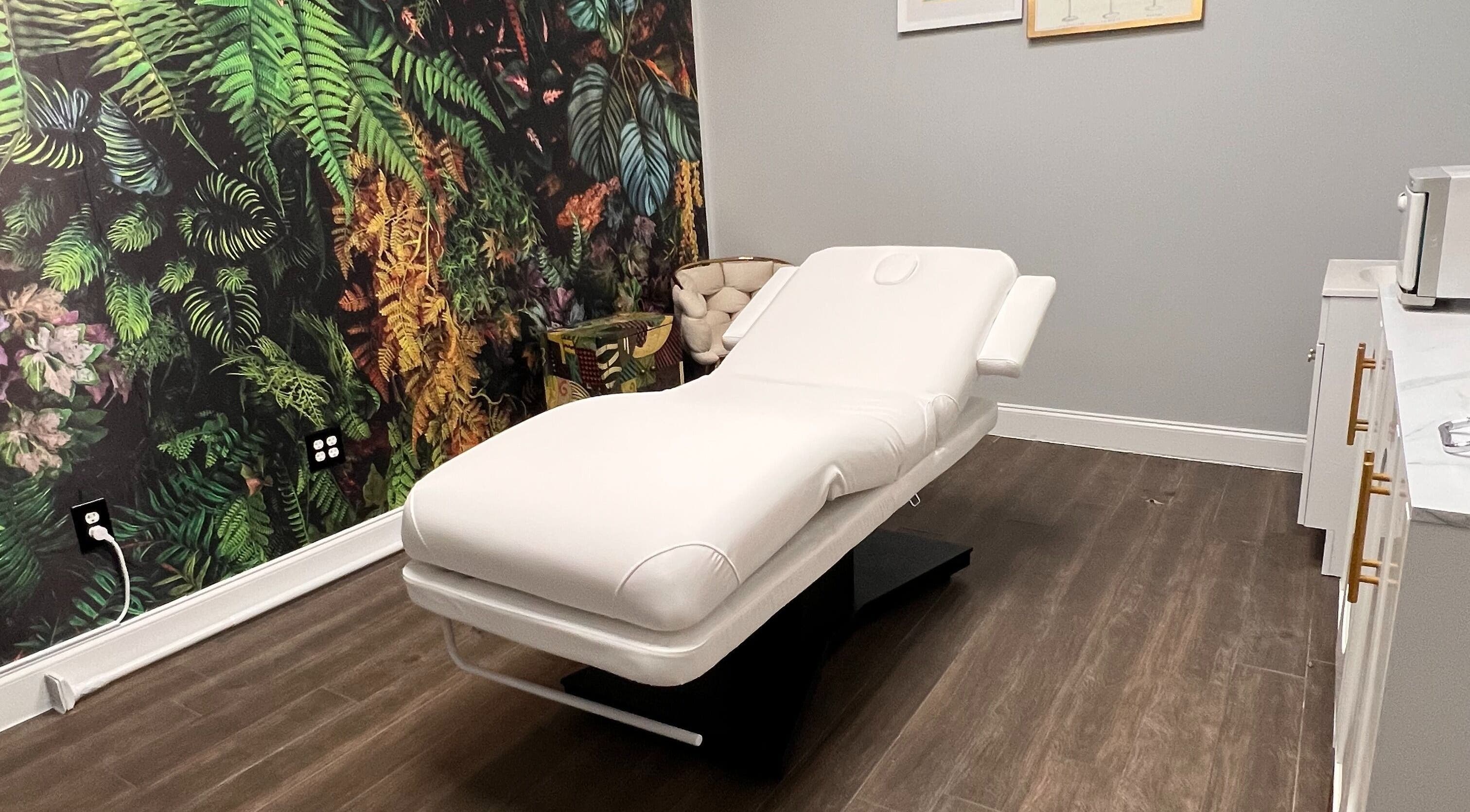 Luxurious treatment room at THE REVIVE BAR, Allen, Texas, US with a spa bed and tropical decor.