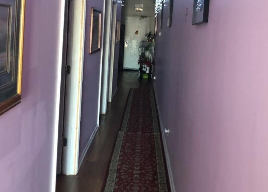 Calming hallway of Rainbow Spa, featuring purple walls and art in Schaumburg, Illinois, US.
