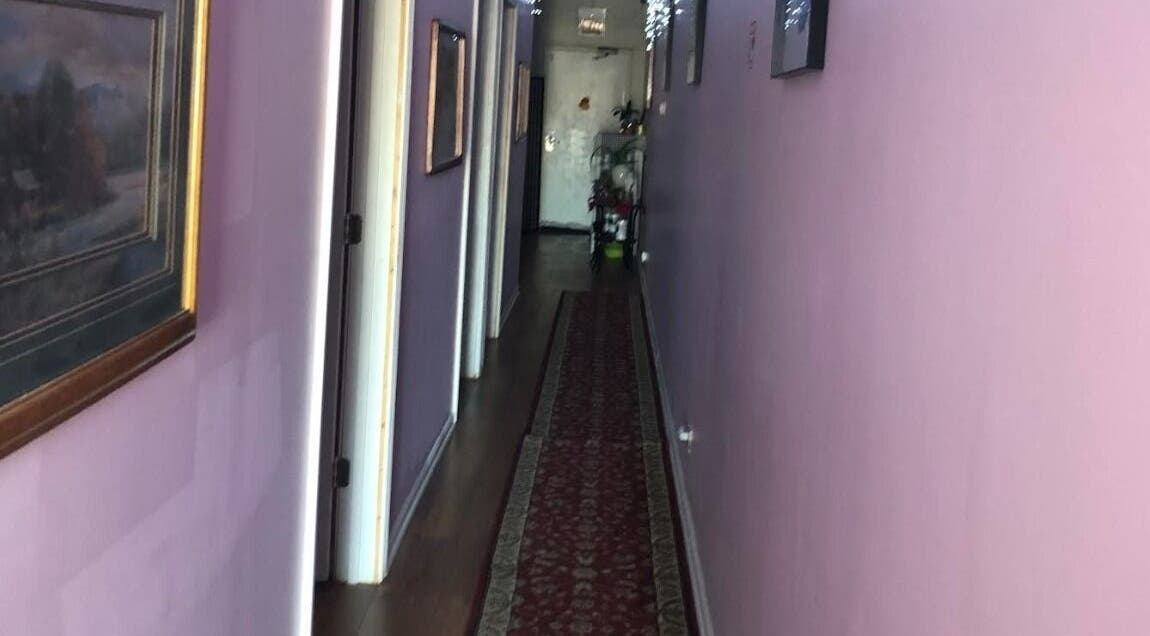 Calming hallway of Rainbow Spa, featuring purple walls and art in Schaumburg, Illinois, US.