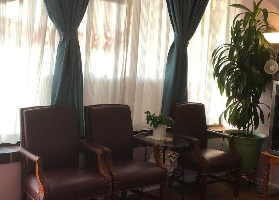 Elegant waiting area at Rainbow Spa, Schaumburg, Illinois, US with plush chairs and greenery.