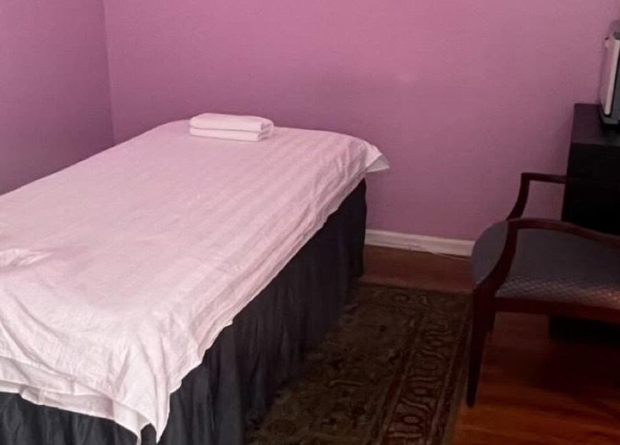 Cozy massage room at Rainbow Spa, Schaumburg, Illinois, US with purple walls and a massage table.