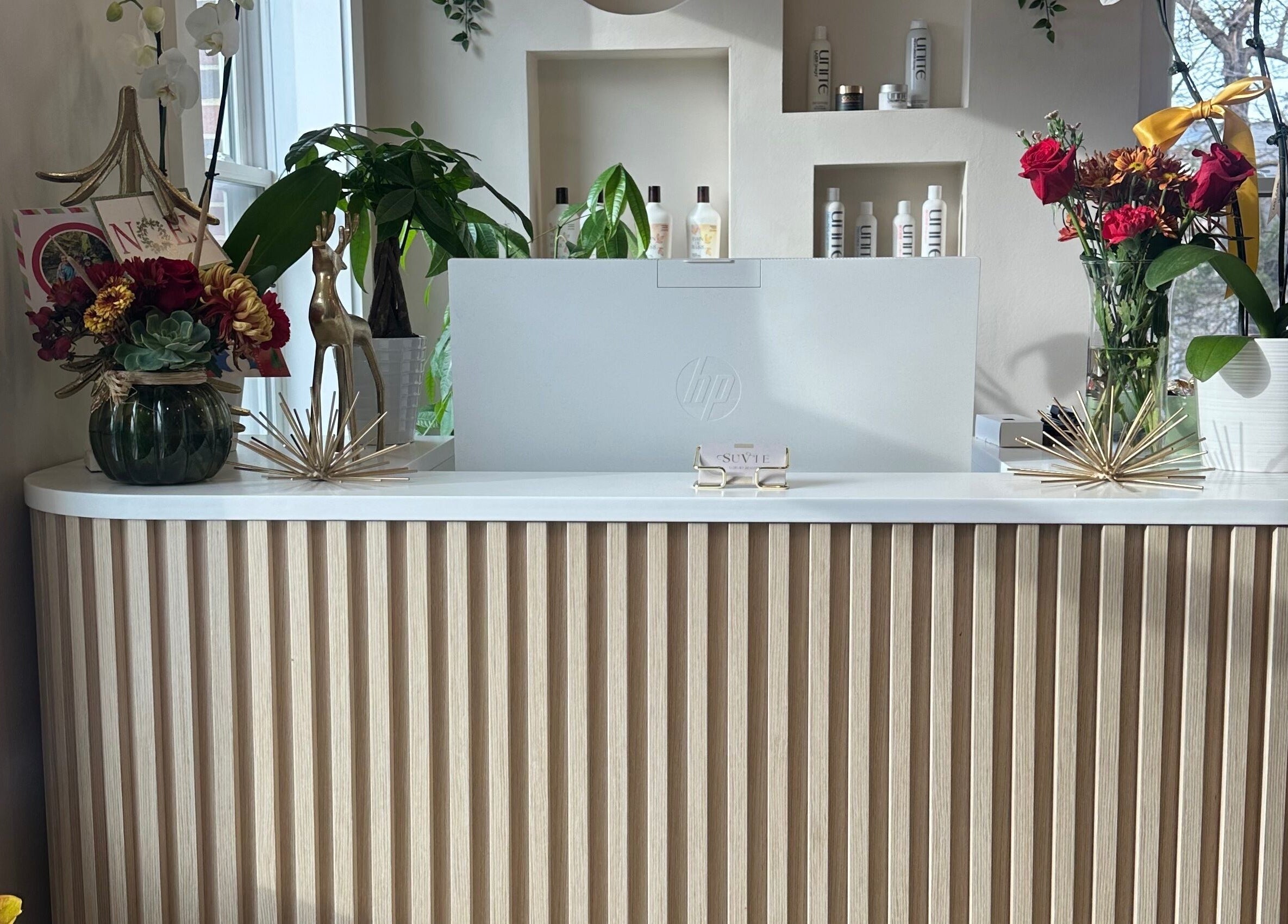 Reception at SuVie Salon and Suites in Alexandria, Virginia, US, featuring elegant decor and floral arrangements.