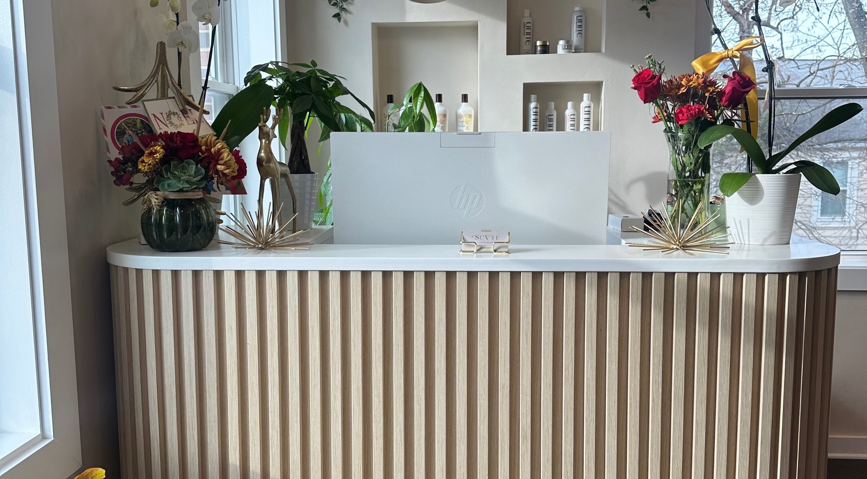 Reception at SuVie Salon and Suites in Alexandria, Virginia, US, featuring elegant decor and floral arrangements.