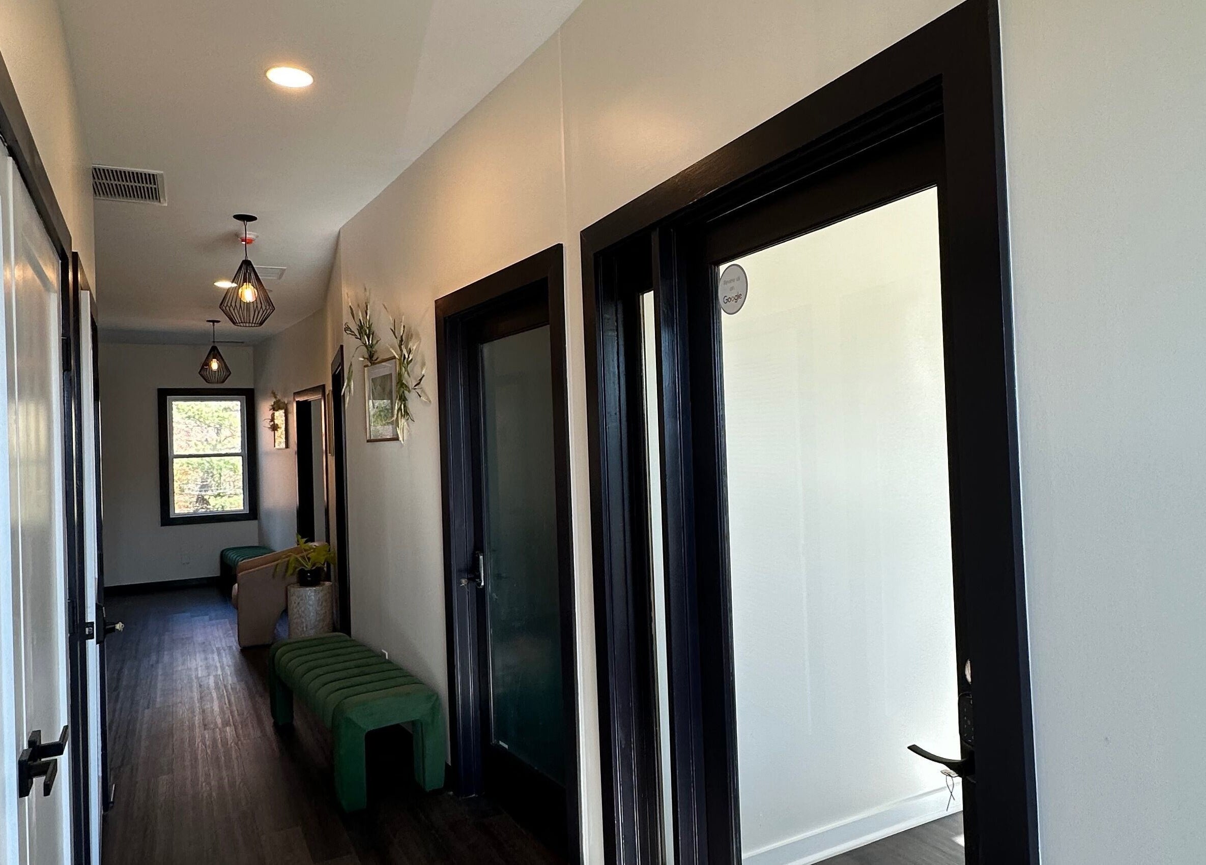 Elegant corridor at SuVie Salon and Suites, Alexandria, Virginia, US, featuring modern lighting and seating.