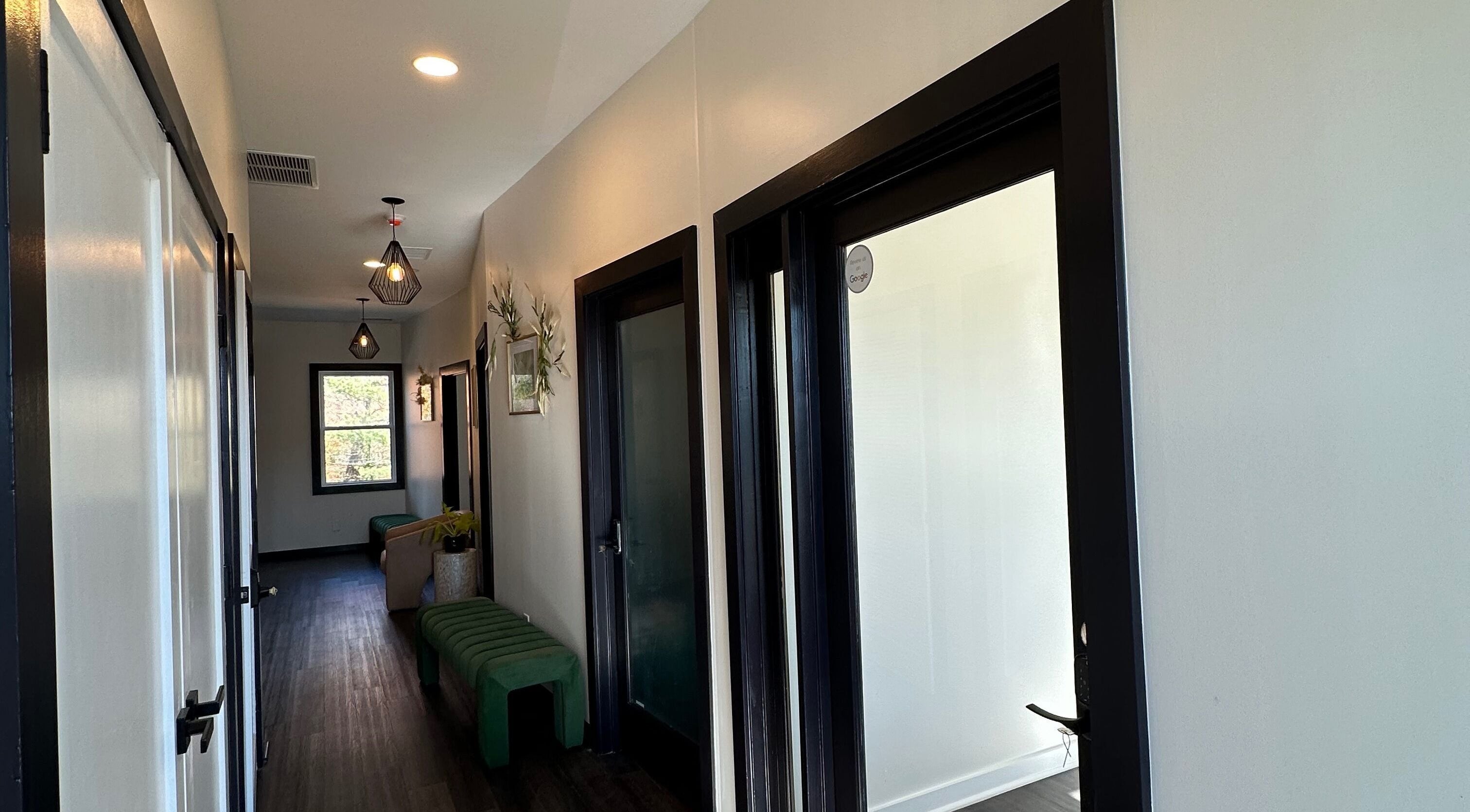 Elegant corridor at SuVie Salon and Suites, Alexandria, Virginia, US, featuring modern lighting and seating.