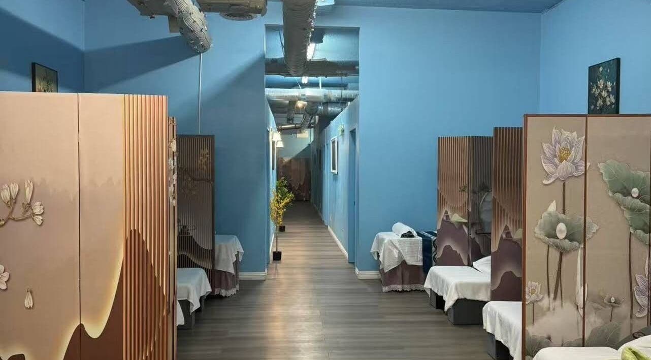 Calming massage rooms at XINGXING MASSAGE in Pomona, California, US with serene blue walls and floral partitions.
