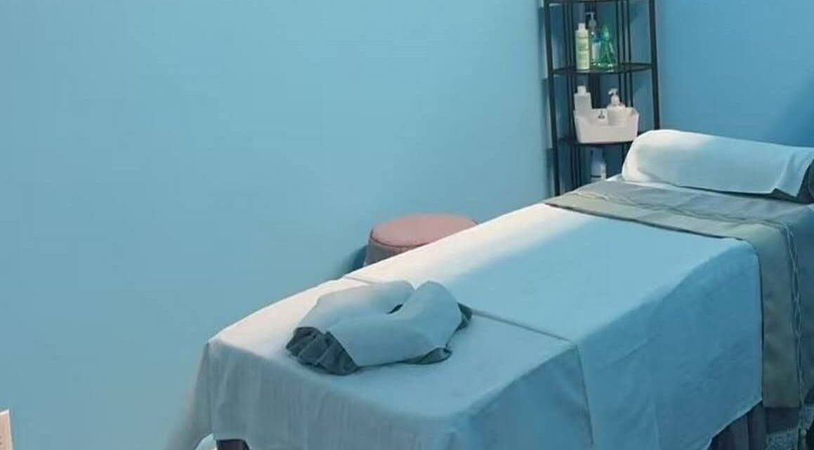 Relaxing massage room at XINGXING MASSAGE in Pomona, California, US with tranquil blue tones and spa equipment.