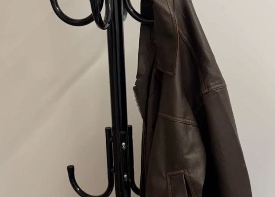 Modern coat rack with leather jacket at DreadsbyDy, London, England, GB. Stylish entryway accent.