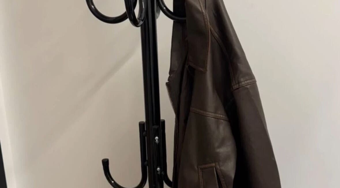 Modern coat rack with leather jacket at DreadsbyDy, London, England, GB. Stylish entryway accent.