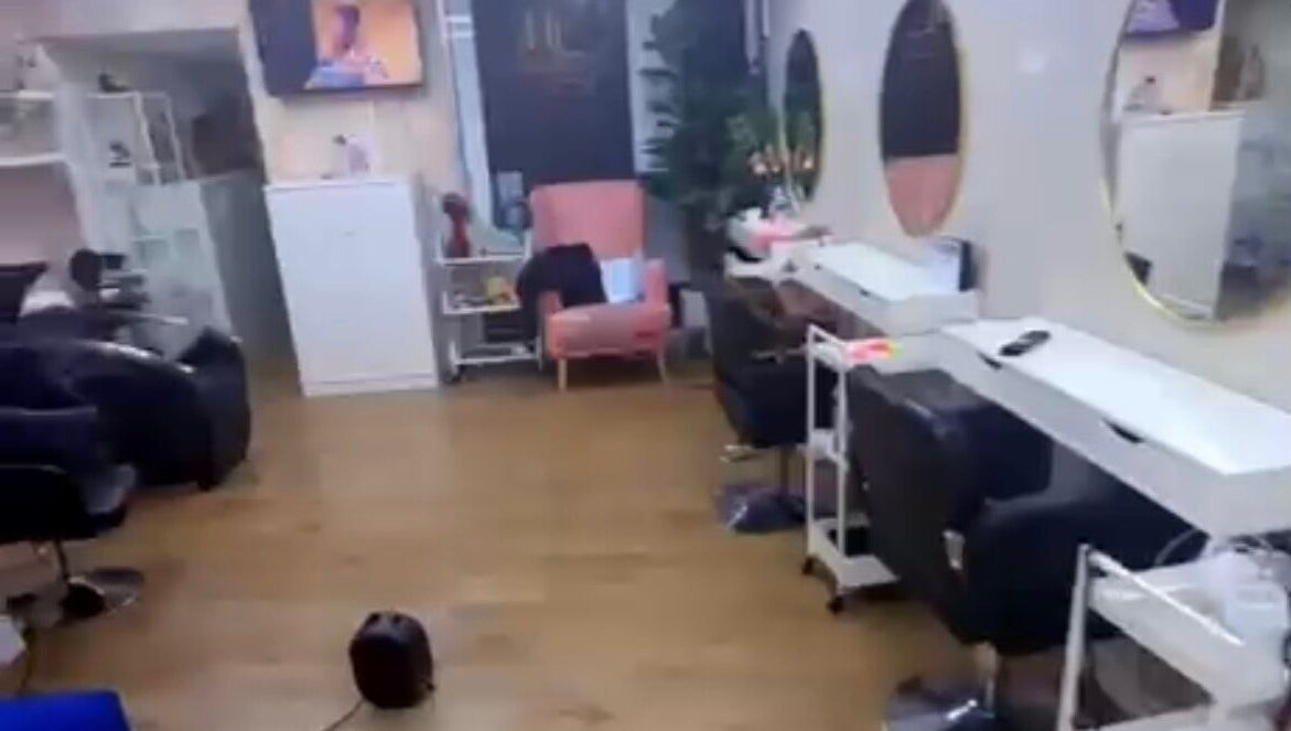 Modern salon interior at Dreadsby Dy, London, England, GB with stylish seating and large mirrors.