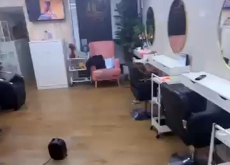 Modern salon interior at Dreadsby Dy, London, England, GB with stylish seating and large mirrors.