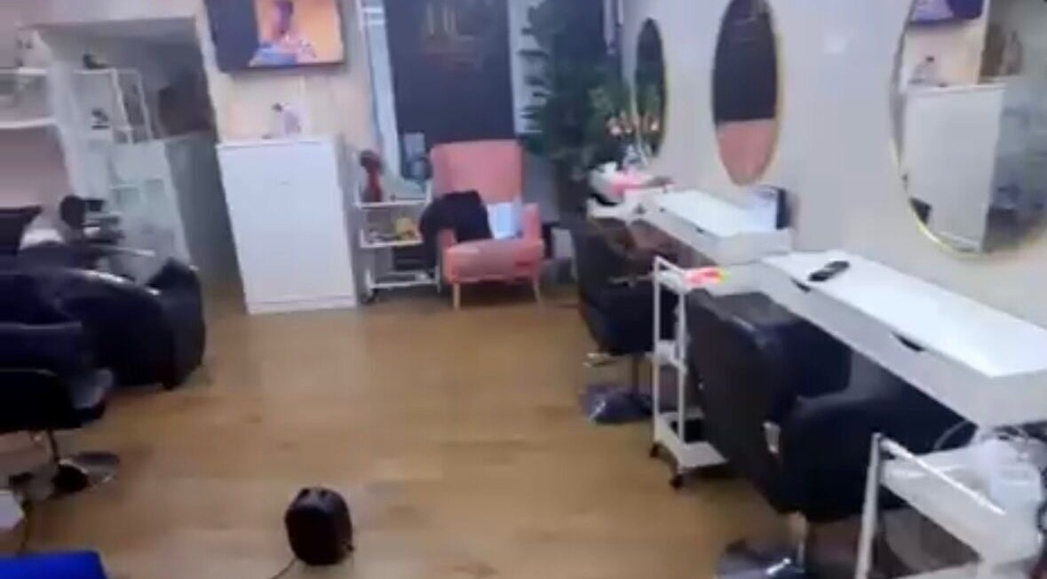 Modern salon interior at Dreadsby Dy, London, England, GB with stylish seating and large mirrors.