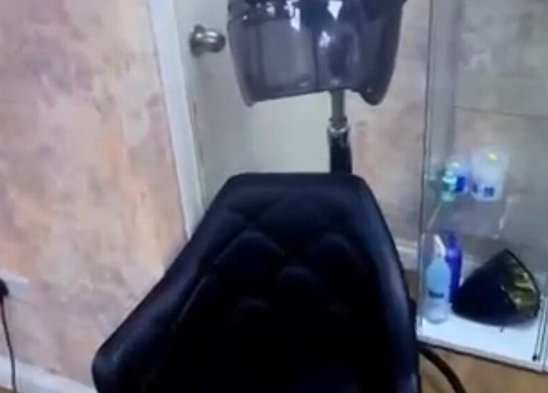 Salon chair and hair dryer at Dreadsby Dy in London, England, GB, showcasing modern styling equipment.