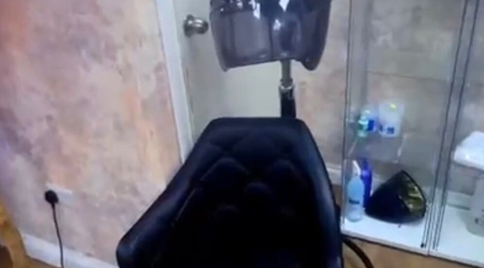 Salon chair and hair dryer at Dreadsby Dy in London, England, GB, showcasing modern styling equipment.