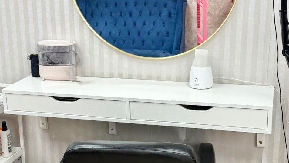 Elegant salon vanity at Dreads by Dy, London, England, GB, featuring a sleek mirror and stylish decor.